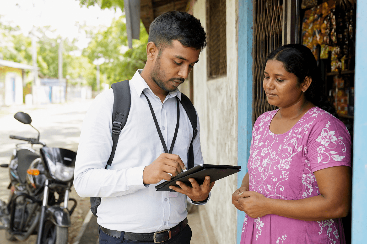 Microfinance field officer recording collections on a tablet