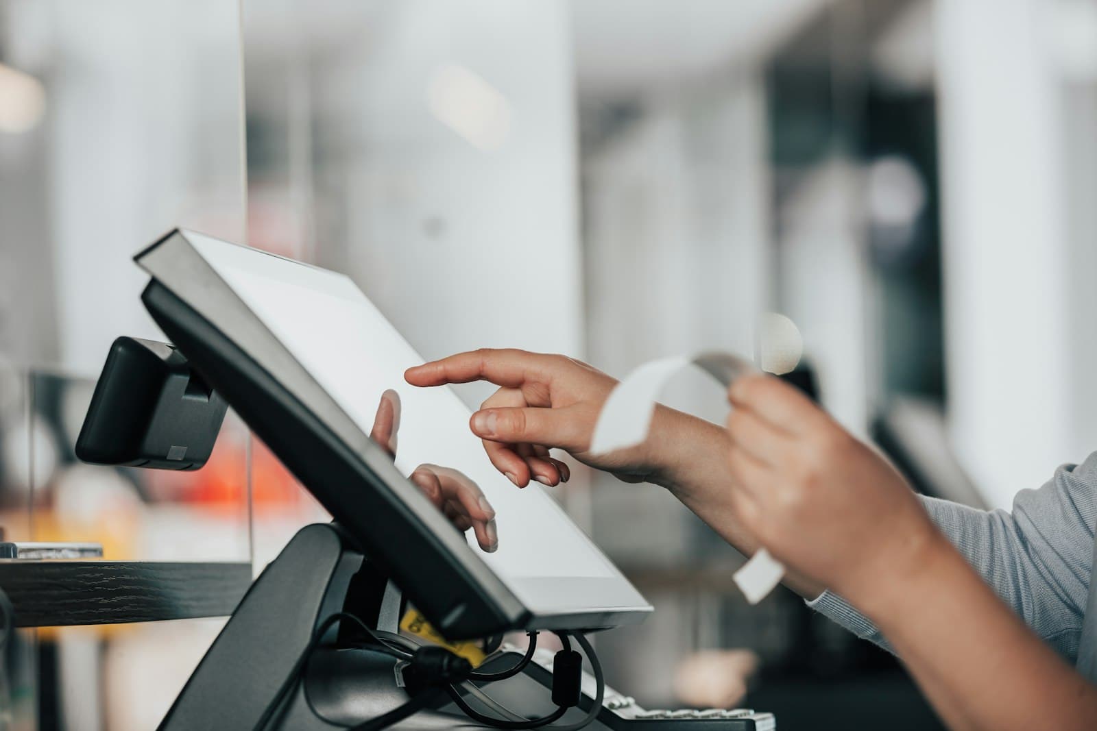 Person using a POS terminal in a retail store for VAT e-invoicing readiness